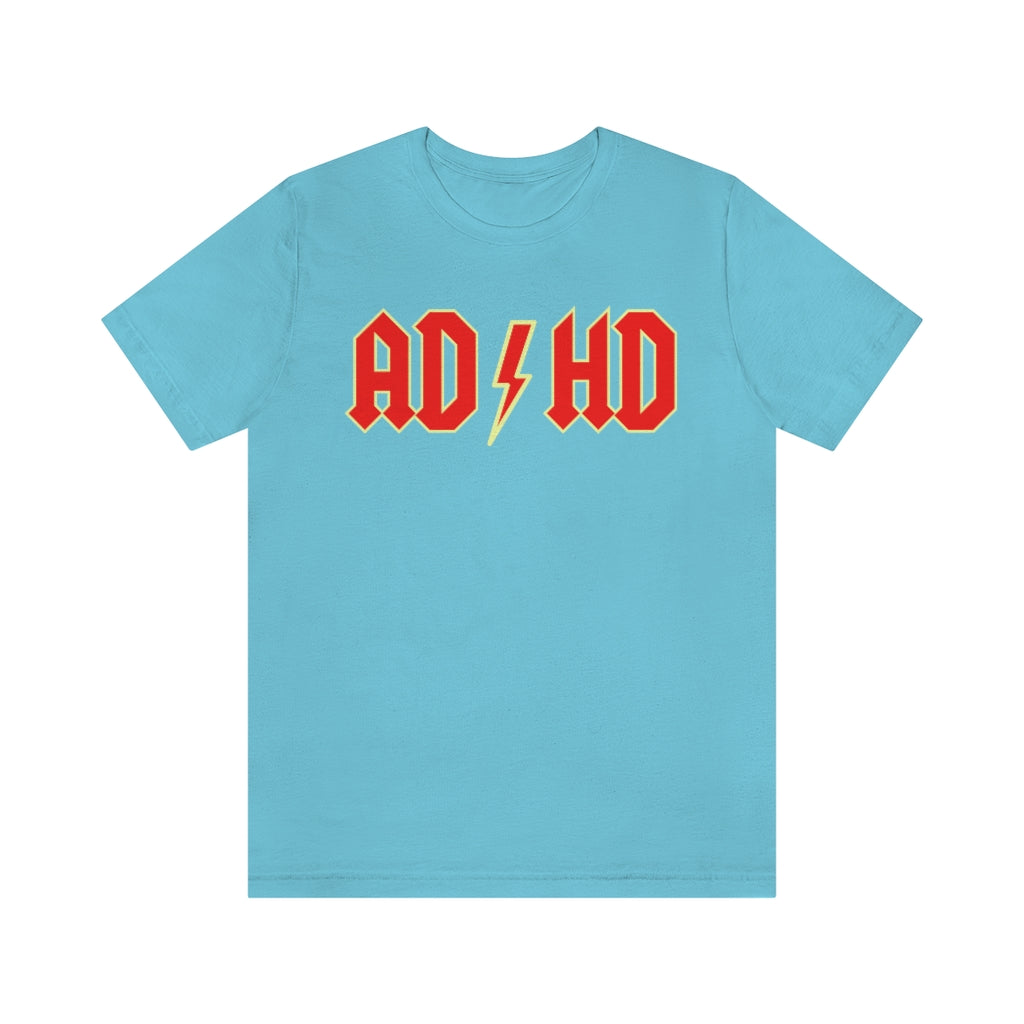 Turquoise t-shirt with red letters with a yellow outline and thunderbolt in the middle saying "ADHD"