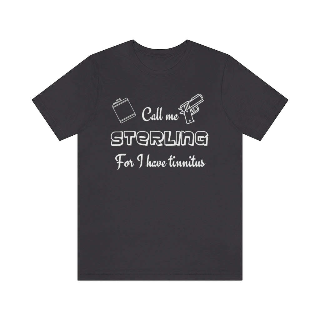 A dark grey-colored t-shirt with in white "Call me Sterling for I have tinnitus" with a gun and alcohol flask outlined.