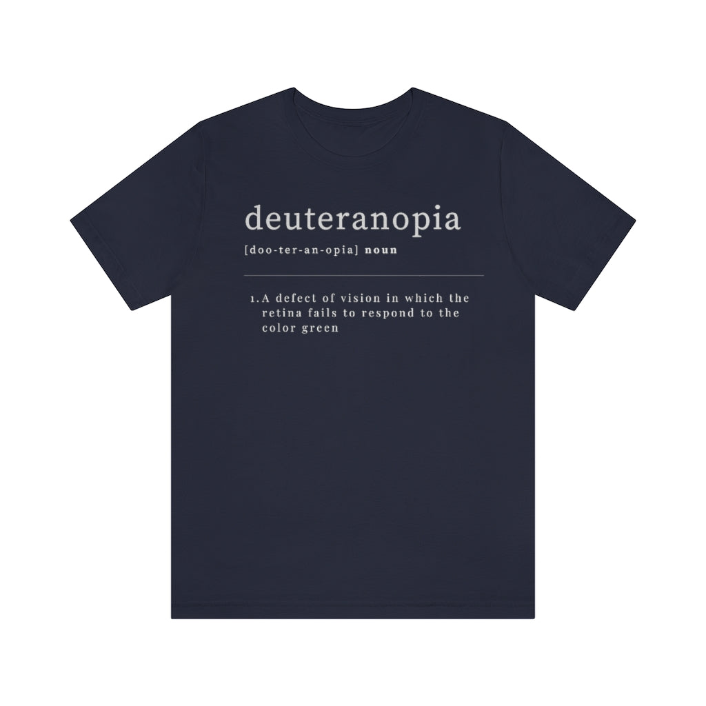 A navy colored t-shirt with text laid out like a dictionary. It reads in white letters: "Deuteranopia, noun. A defect of vision in which the retina fails to respond to the color green."