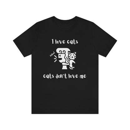 A black t-shirt showing a woman looking away from a cat sneezing, with the text "I love cats, cats don't love me"