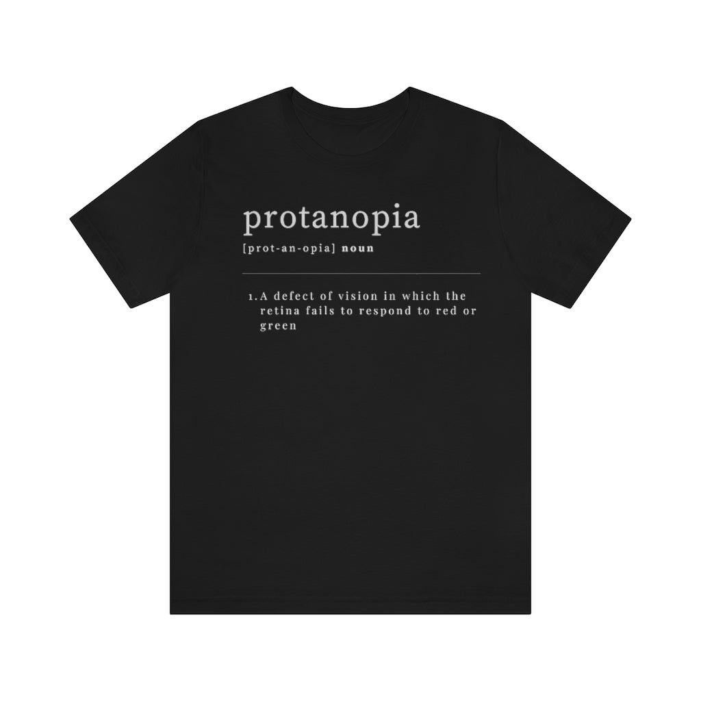 A black t-shirt with text laid out like a dictionary. It reads in white letters: "protanopia, noun. A defect of vision in which the retina fails to respond to red or green."
