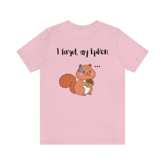 A pink t-shirt with a cute drawn squirrel holding an acorn in his hands. A teardrop on top of his head and 3 dots on his side with the text "I forgot my EpiPen".  His cheeks are filled.