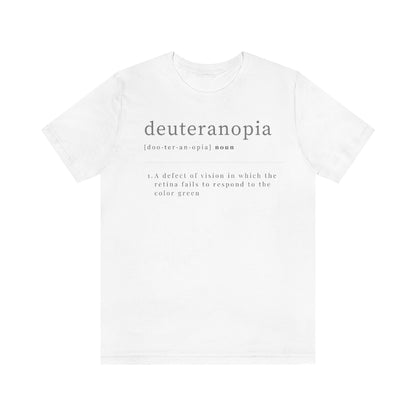 A white t-shirt with text laid out like a dictionary. It reads in black letters: "Deuteranopia, noun. A defect of vision in which the retina fails to respond to the color green."