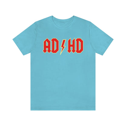 Turquoise t-shirt with red letters with a yellow outline and thunderbolt in the middle saying "ADHD"