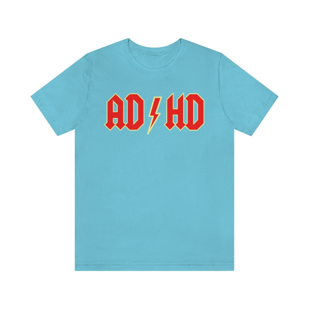 Turquoise t-shirt with red letters with a yellow outline and thunderbolt in the middle saying "ADHD"