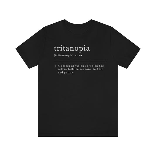 A black t-shirt with text laid out like a dictionary. It reads in white letters: "Tritanopia, noun. A defect of vision in which the retina fails to respond to blue and yellow.