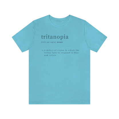 A turquoise t-shirt with text laid out like a dictionary. It reads in black letters: "Tritanopia, noun. A defect of vision in which the retina fails to respond to blue and yellow. "
