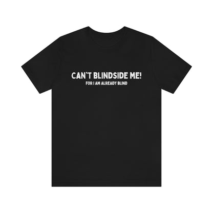 A black t-shirt with white text saying in a big font "Can't blindside me!" with under it a smaller font saying "for I am already blind"