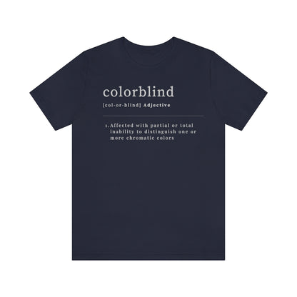 Navy colored t-shirt with white text made like a dictionary saying: "Colorblind, adjective. Affected with partial or total inability to distinguish one or more chromatic colors"