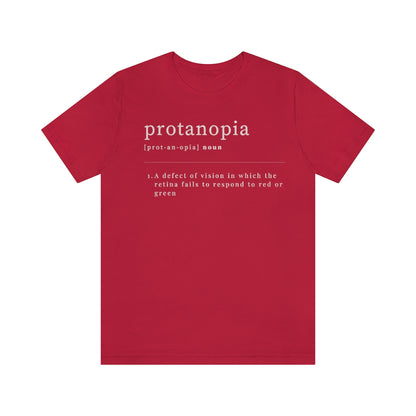 A red t-shirt with text laid out like a dictionary. It reads in white letters: "protanopia, noun. A defect of vision in which the retina fails to respond to red or green."