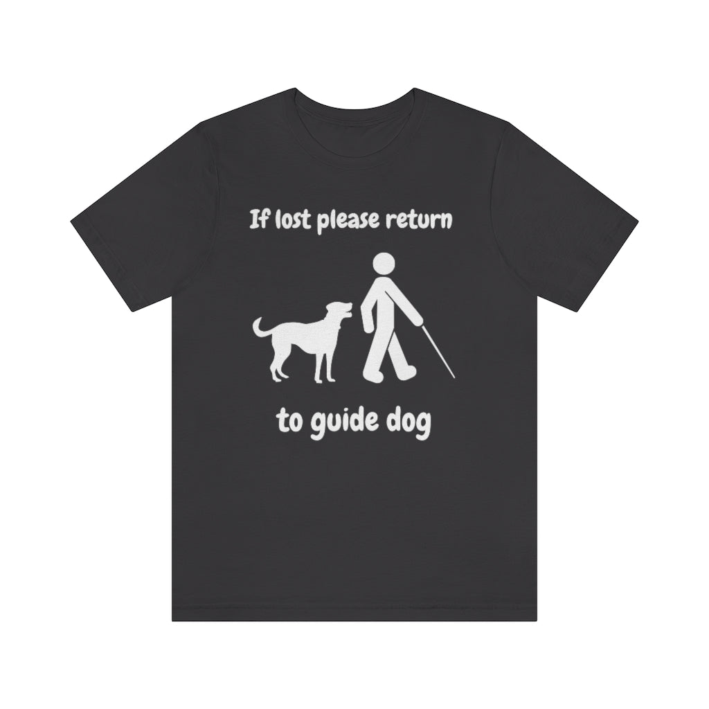 A dark grey t-shirt with the text "If lost please return to guide dog",with a picture of a man with a cane walking away from a dog.