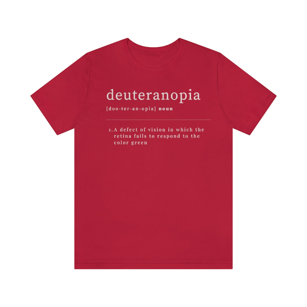 A red t-shirt with text laid out like a dictionary. It reads in white letters: "Deuteranopia, noun. A defect of vision in which the retina fails to respond to the color green."