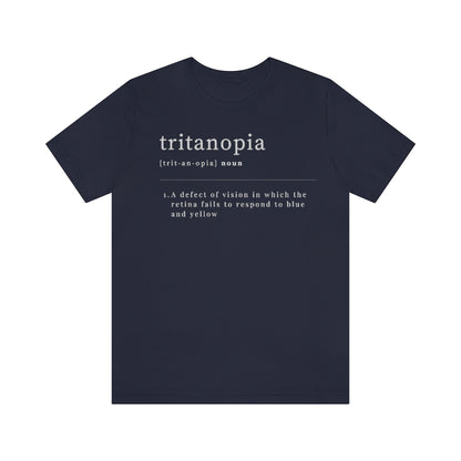 A navy t-shirt with text laid out like a dictionary. It reads in white letters: "Tritanopia, noun. A defect of vision in which the retina fails to respond to blue and yellow.