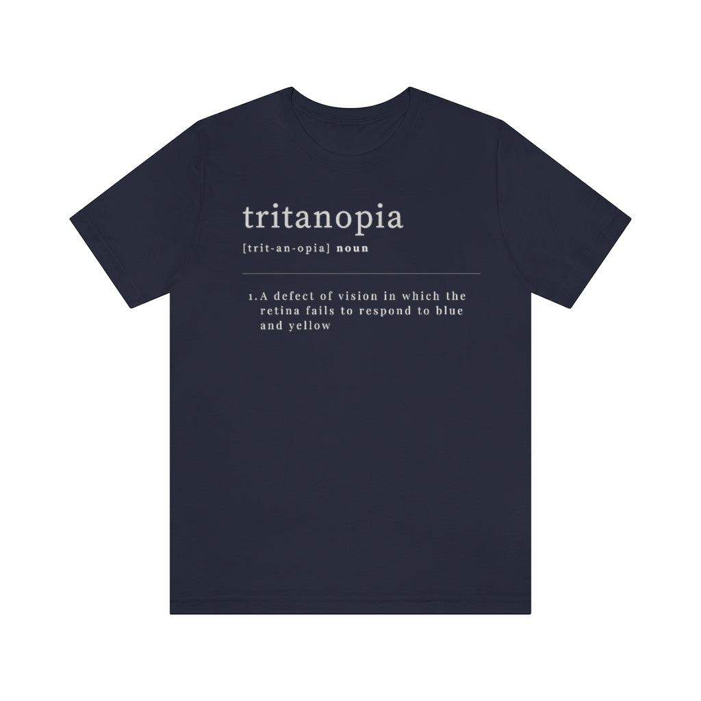 A navy t-shirt with text laid out like a dictionary. It reads in white letters: "Tritanopia, noun. A defect of vision in which the retina fails to respond to blue and yellow.
