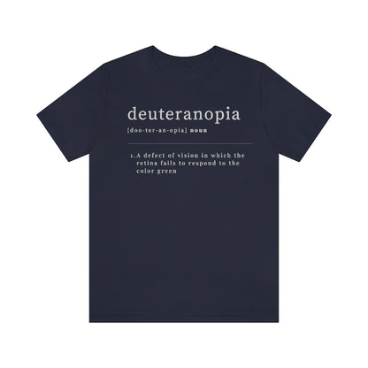 A navy colored t-shirt with text laid out like a dictionary. It reads in white letters: "Deuteranopia, noun. A defect of vision in which the retina fails to respond to the color green."