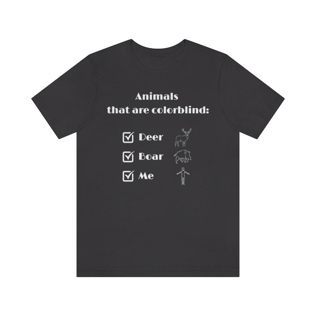 A dark gray colored T-shirt with white text reading: "Animals that are colorblind:". Under it are 3 checked boxes with the words "Deer", "Boar" and "Me". Behind these are outline drawings showing the animals and a human.