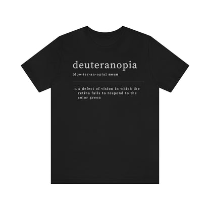 A black t-shirt with text laid out like a dictionary. It reads in white letters: "Deuteranopia, noun. A defect of vision in which the retina fails to respond to the color green."