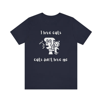 A navy colored t-shirt showing a woman looking away from a cat sneezing, with the text "I love cats, cats don't love me"