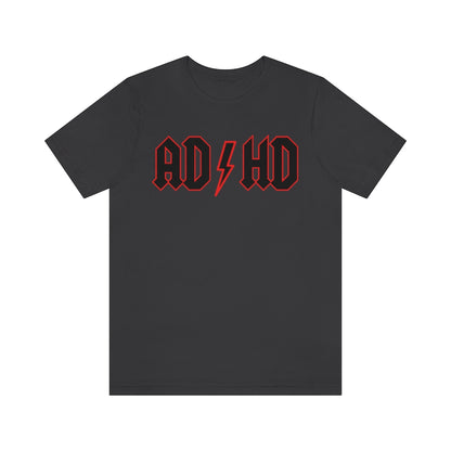 Dark grey colored t-shirt with black letters with a red outline and thunderbolt in the middle saying "ADHD"
