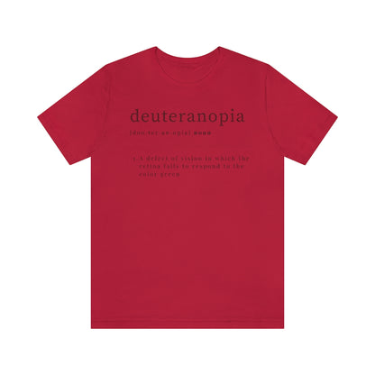 A red t-shirt with text laid out like a dictionary. It reads in black letters: "Deuteranopia, noun. A defect of vision in which the retina fails to respond to the color green."