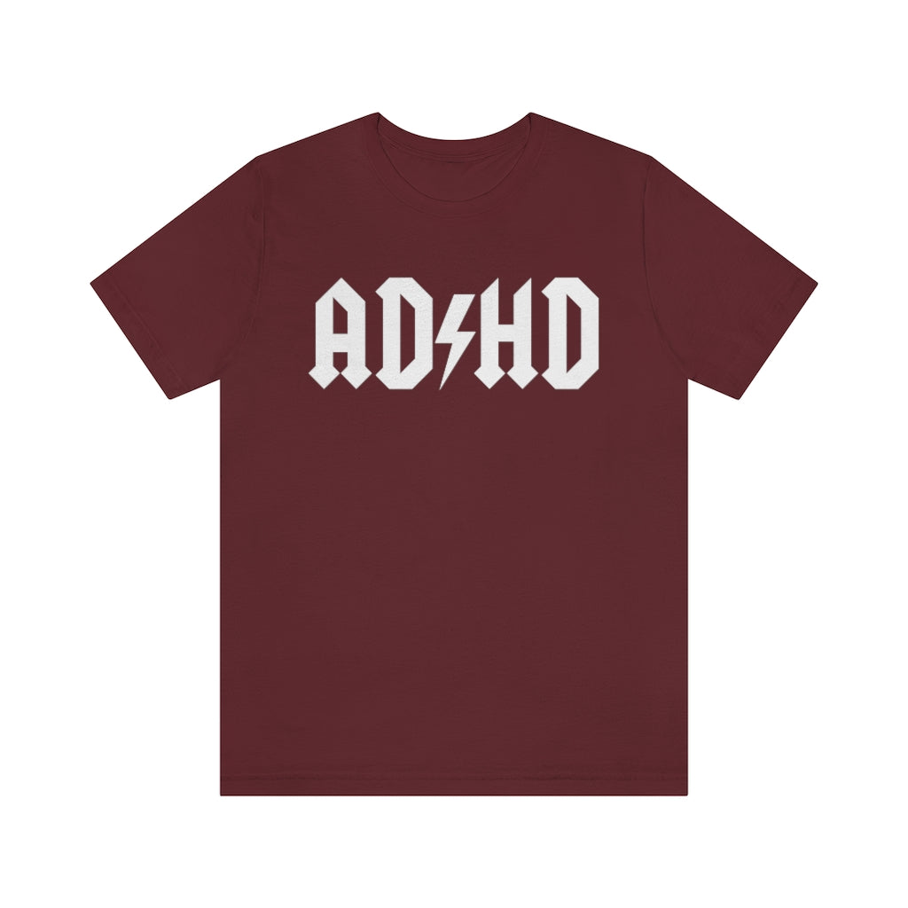 Maroon colored t-shirt with white letters with and thunderbolt in the middle saying "ADHD"