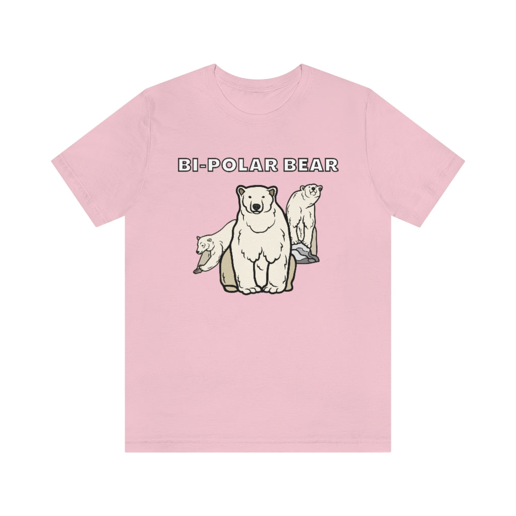 A pink t-shirt with white text saying: "Bi-Polar bear). Under it are 3 bears: One staring neutrally at the viewer, on the right one on a rock looking happy and on the left one looking sad while jumping away.