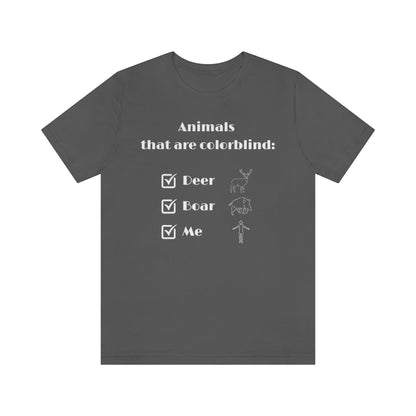 An asphalt colored T-shirt with white text reading: "Animals that are colorblind:". Under it are 3 checked boxes with the words "Deer", "Boar" and "Me". Behind these are outline drawings showing the animals and a human.