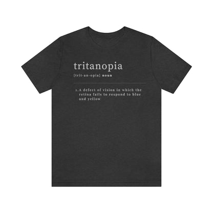 A dark grey heather t-shirt with text laid out like a dictionary. It reads in white letters: "Tritanopia, noun. A defect of vision in which the retina fails to respond to blue and yellow.