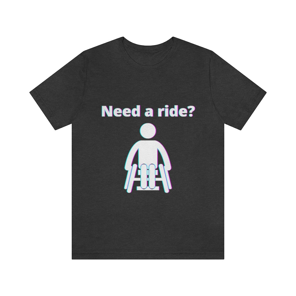 Dark grey t-shirt with a person in wheelchair with text in glitch effect saying: "Need a ride?"